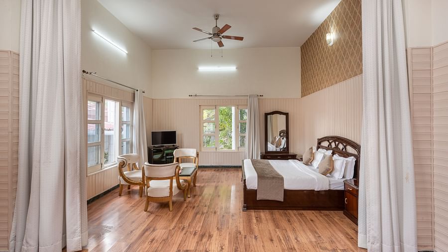 Luxurious suite featuring a bedroom and a living area at DLS Tehri Club Resort.
